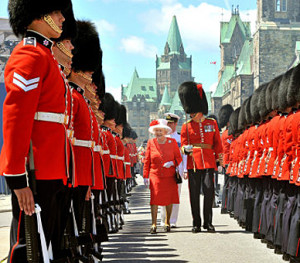 Queen Elizabeth II inspects a Guard of Honour outside the Canadian Parliament, after arriving to attend the Canada Day celebrations, in Ottawa, Canada.