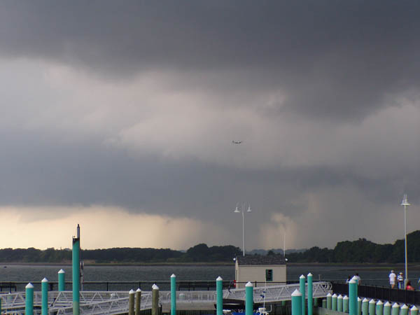 plane flying through storm over ocean